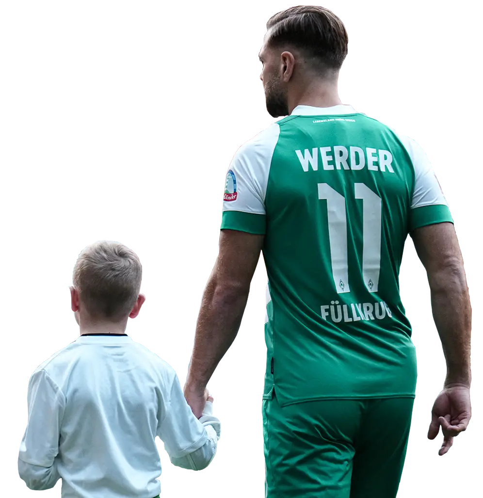 Ein Fußballspieler in grünem Trikot hält ein Kind mit weißem Pullover an der Hand, sie wurden von hinten fotografiert (Foto)