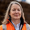 Individual Portrait of Christine Hein in an orange safety jacket (Photo)