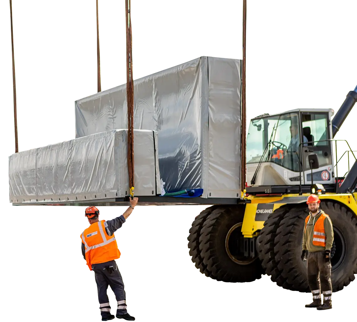 A crane transporting heavy objects, 2 people in protective clothing are in the foreground (Photo)