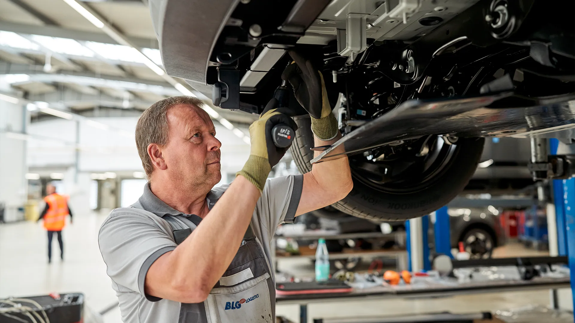 Mechanic working underneath a vehicle (Photo)