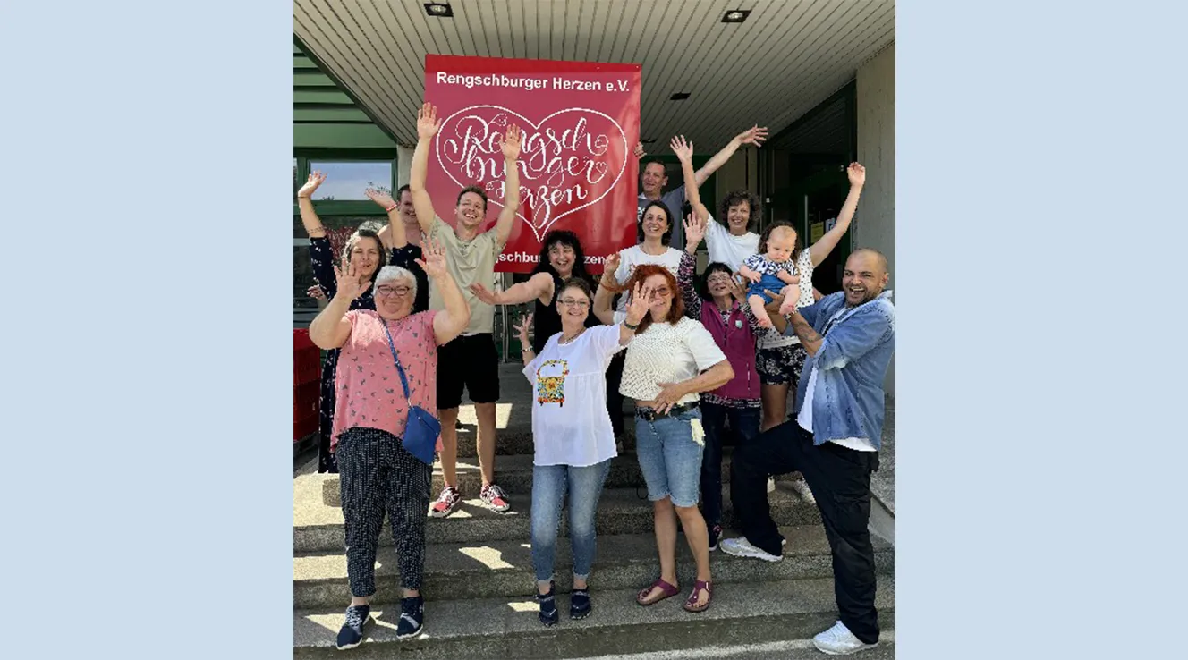 Cheerful group photo with raised hands (Photo)